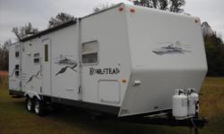 Hayden, AL-2004 Starcraft Homestead 29BHS Travel Trailer. The overall length 31'. It features a new awning, slideout in the living room, queen size bed in the front bedroom and bunk beds in the back. The couch is a pull out type which totals sleeping