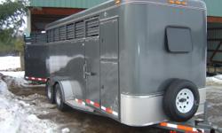 Gray "steel" 4 horse straight load trailer. 7 feet tall, nice and wide, have hauled 2 belgians comfortably and 4 large quarter horses. Also can hold 130 square bales of hay. 16' long, treated flooring with mats, swing rear gate, semi round front, solid