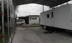 Full size refrigerator, big screen tv, queen size bed. Trailer sitting on 25x41 ft concrete pad with a 24x40 ft canopy over it plus 8x12 storage shed. Travel trailer in very good condition. pulled very little. Lot rent $140.00 a month. cell:765-776-6451