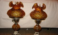Pair of beautiful antique Fenton glass bedroom&nbsp;lamps.&nbsp; Poppy pattern in amber glass w/ brass trim.&nbsp; No chips or dings and are complete with glass shades and chimneys.&nbsp; $550. for the pair.