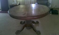 it is an antique round table from the 1800s. it has 4 claw feet and it has 3 leafs to it. It has been in my parents attic for 50 yrs. The top needs some work , but is in good shape
