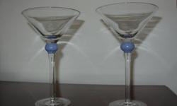 Lovely art-deco cosmopolitan glasses with blue hand-blown accents add an elegant and updated look to any occasion. Set of two.