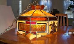 Authentic stained glass hanging lamp made by the Other Brothers Artglass Company for Anheuser Busch. Only a few such lamps were made for the bar at the brewery in St. Louis. I bought this lamp at The Other Brothers design studio in the mid 1970s. The