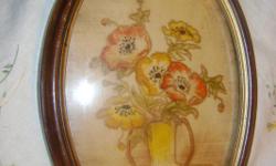 this is a very old floral drawing 0 - am not sure what the medium is - could be colored pencils - could be paint or pastels cant really tell - it is beautifully framed in an oval wooden frame - this is one of 2 that i am listiing