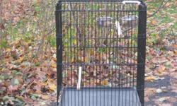 Pet Cage ideal for African gray parrot size bird or small animal. Comes with wooden perches, stainless steel food/water cups, pull out bottom tray, removable carry handle. Excellent condition.