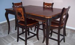 Beautiful high seating dining table with removable leaf & 4 chairs. Excellent condition. Contact 729-3185.