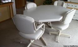 White table and 4 white vinyl chairs - original cost $1100.00.&nbsp; Chairs are very comfortable-rollers, padded seats, can lean back.&nbsp; Only getting rid of them because new floor can't have rolling chairs on it.