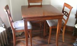 Pub style wooden dining table and four chairs with upolstered seats