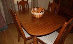 Table with 4 chairs and leaf. Leaf makes table 70". Cloth seats on chairs. Excellent condition