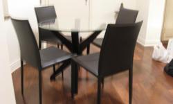 Galss top round dining table (36") with wodden base and 4 matching leather chairs only 3 years old. Perfect for small aprtment. Call 917-558-5813 or e-mail sanchita.d.gupta@gmail.com