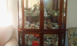 Lovely Display Cabinet: This display cabinet is the perfect piece of furniture for showing off your collectibles. It has an oak finish with large glass doors. It is two pieces with overall measurements of 6?8? high, 4? wide, 17? deep on the outside and