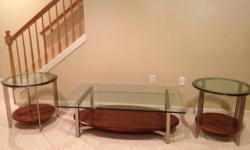 Beautiful Ethan Allen coffee table and two end table set made of glass, wood and metal. Perfect condition. Asking $700.