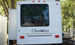 2005 cherokee camper 38 foot with two slides, bumper hitch, will sleep 9. Has two bed rooms: master bedroom has full size bed built in dresser two closets and a big bay window. Second bedroom has two bunk beds built in dresser with one closet. Bathroom