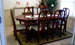 Beautiful Cherry Formal Dining Set with 6 chairs and an extra leaf. The chairs are queen anne high back , white covered fabric. Set like new. Moving and no room left for the set.