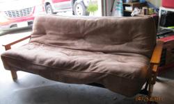 Hardwood futon with brown cushion. Folds out into a double bed. Excellent condition.