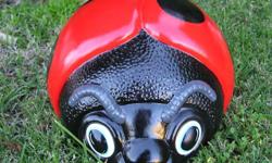 Ceramic. 11 1/2" L X 7" T X 9 1/2" W Pretty lady has been done in bright red paint with big black spots. If desired you can order her with smaller spots. She has been weatherproofed top & bottom to withstand the sun & moisture. Pretty Lady is a trillion