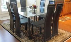 Beautiful 54" x 54" Glass Dining Room table and 8 black leather chairs. Furniture is from House of Denmark Furniture store. A few unnoticeable scratches. Great condition. Moving sale.