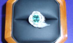 This is a stunning 3.64CT mint tourmaline circled by .70CT VS diamonds in an 18K white gold setting. A $135 GIA certification and the original purchase receipt is included in the price. My wife passed a few years ago and I'm selling this at a fraction of