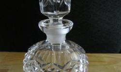 Heavy crystal perfume bottle with X-shaped design on the bottle and the stopper, in perfect condition. Looks like Waterford and has a nice heavy weight. This is not marked. This measures approximately 5 1/2 inches tall and 3 inches wide.