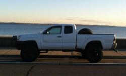 I am selling my 2006 Toyota Tacoma, white, access cab with 68,000 miles on it. 5spd Manual Its in great condition with a 6" ProComp Lift and 35" BFG A/T tires. It's got a flowmaster side exit exhaust and an ARB Bull Guard Bumper (Black), Black Steel