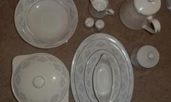 fine china set that serves twelve people: 12 small and larger dinner plates, 12 salad and soup bowls, 12 saucer plates, 12 large and small tea and coffee cups with saucers,&nbsp;a&nbsp;tea pot, a sugar and a cream dispencer. 3 serving plates -&nbsp;small,