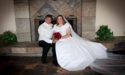 White, modest wedding dress comes with veil,&nbsp;slip and bra. Originally dress was size 22, but altered to size 18.&nbsp; I had bought newshoes to wear with my wedding dress, but the shoes hurt my feet so bad that day, that I took them off.&nbsp;Got