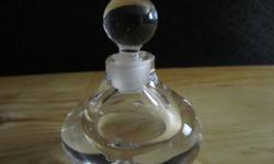 Beautiful Orrefors perfume bottle in great condition. This is a clear bottle with a rounded design with indent in center. This measures 3 inches tall and is 2 1/2 inches wide.