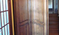 Entertainment Center/Armoire manufactured by Pennsylvania House. This piece is wood, finished with a medium brown tone. Perfect for a bedroom or living room, this armoire features two doors that conceal interior. As you can see from the interior photo,