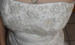 the dress is a size 6 with no alterations. it is a mermaid style dress that is white and has a silver design on it. was $500 from davids bridal but asking only&nbsp;$200. it has never been worn and even has the tags on it. for more info call or text .