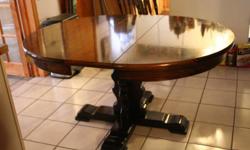 Very nice solid - wood dining room table and china cabinet. The table has 6 matching chairs and 1 extender piece.