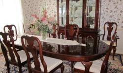 Thomasville table with 6 chairs and 2 captain chairs, excellent condition, leaves, and lighted hutch and custom made padded protective cover.