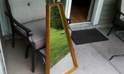 Trapezoid-Shaped, padded, gold wood trimmed wall mirror with brackets. Other than the need for cleaning, is in excellent condition ! Measures 21"(across the bottom), x 8"(across the top) x 37 1/4" tall. The frame is very sturdy(presumably made of maple).
