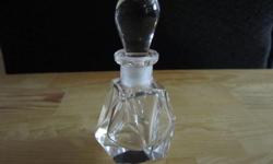 Beautiful crystal perfume bottle with a triangular design. This is not marked by manufacturer. The bottom half of the stopper is broken; the bottle is in fantastic condition. Measures 4 inches tall and 2 1/4 inches wide.