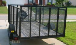 Utility trailer with 4 ft. high mesh caged sides and wood flooring. Cage is 6 1/2 ft wide by 12 1/2 ft long. Single axle, tires like new with brand new spare. Drop gate in rear. Great for landscaping, hauling, trash removal, etc.