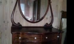 Ladies antique solid wood dresser.&nbsp; Has the original beveled & vintage silvered mirror.&nbsp; Claw foot legs in front.&nbsp; Dove tail joints in the drawers. Glass and metal drawer pulls.&nbsp; Excellent condition.&nbsp; Dresser is 45" wide, 27"