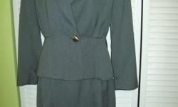 This lovely vintage 90s like new condition Casual Corner suit was made in Columbia of U.S.A. components. Tags do not indicate what materiels the suit is made of. Suit top has sewn in shoulder pads. One pocket at front left. Taylored waistline. Pleates at