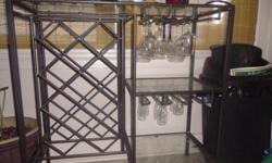 Very nice wrought iron wine rack with two glass shelves and space to hang glasses.&nbsp; $65?obo comes with glasses&nbsp; --